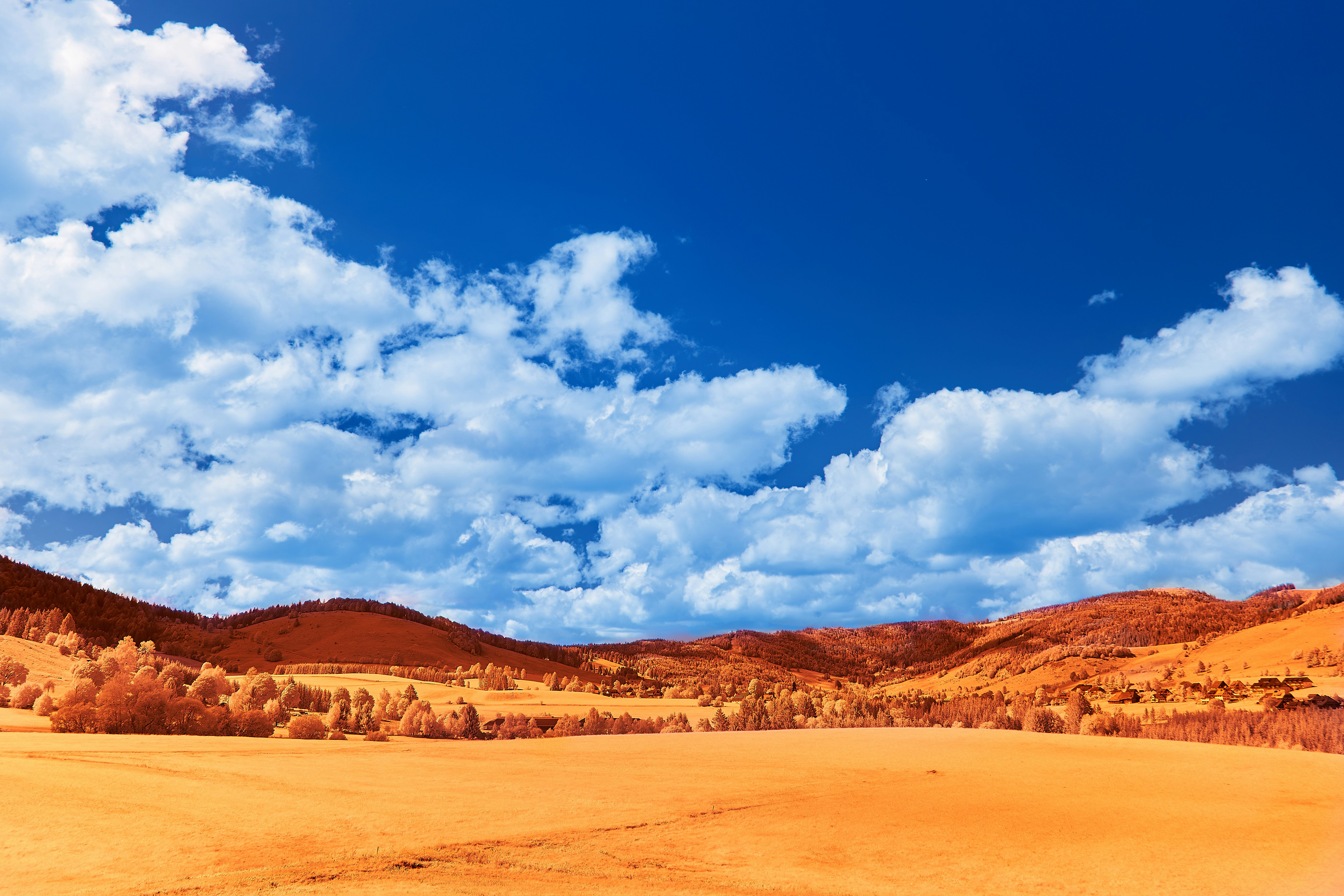 brown sand under blue sky and white clouds during daytime